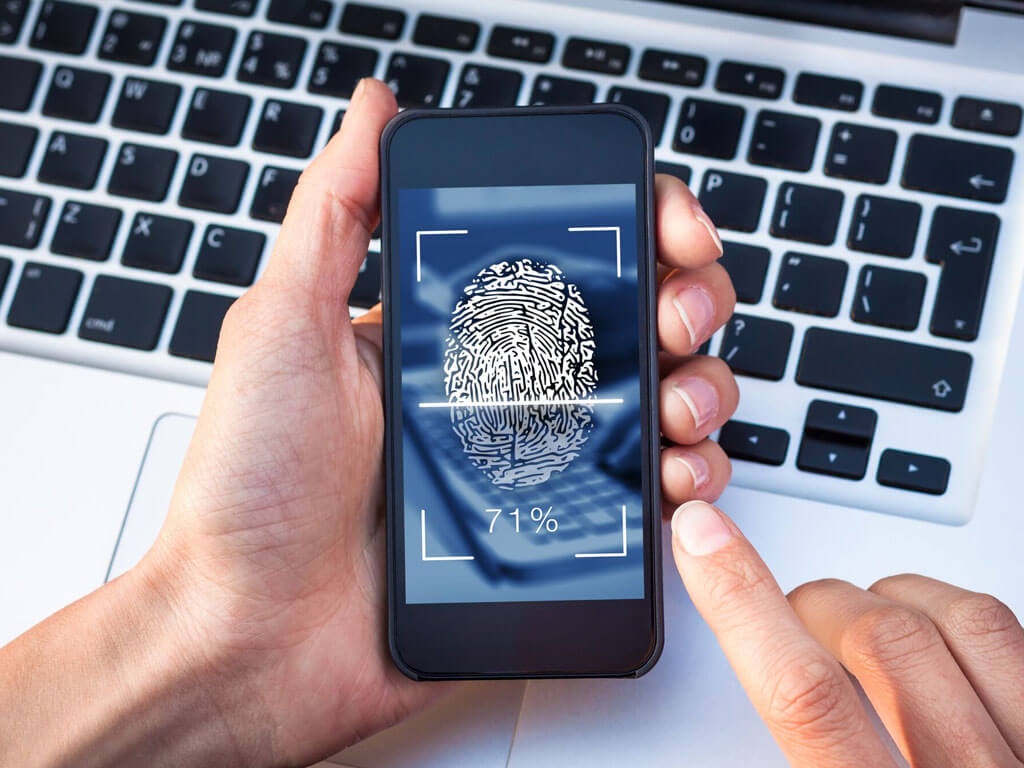 Hand holding a smartphone with fingerprint being scanned