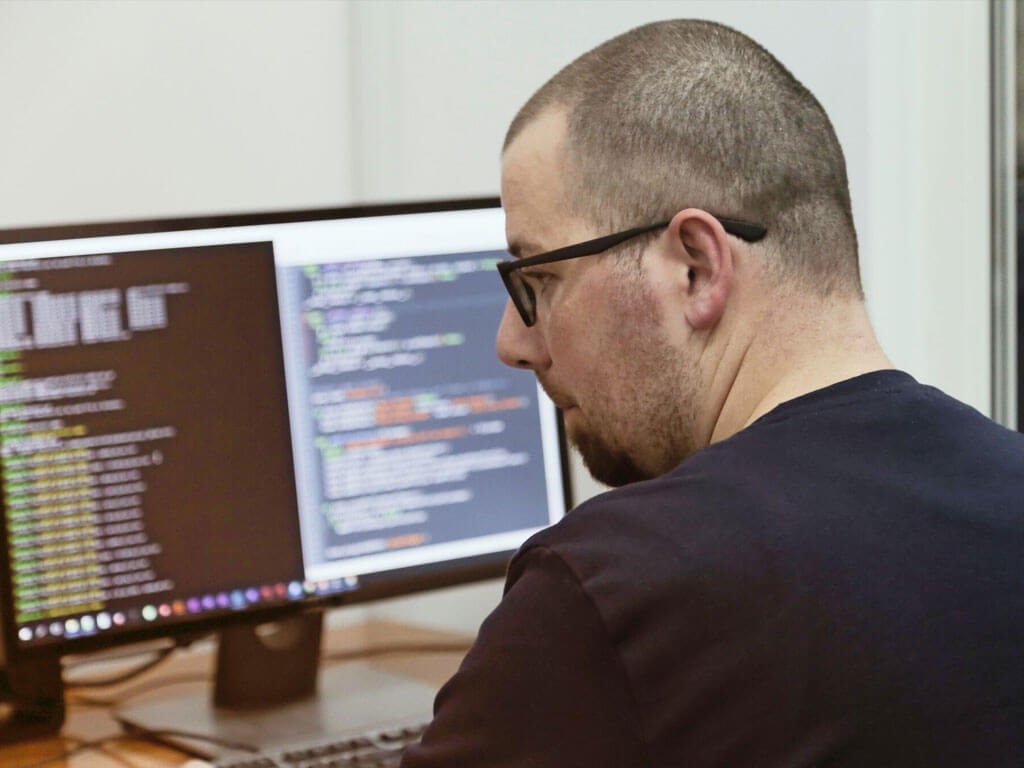 Developer working - desktop screen with code in the background