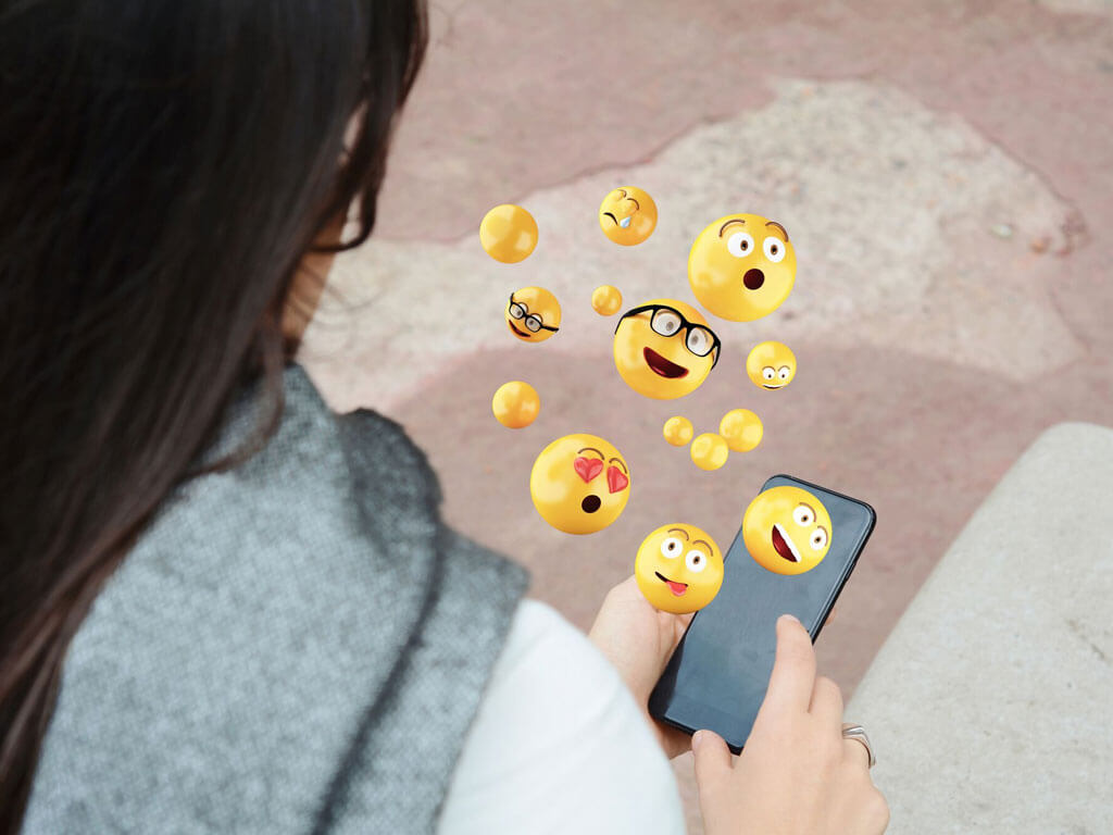 Smileys coming out of a smartphone