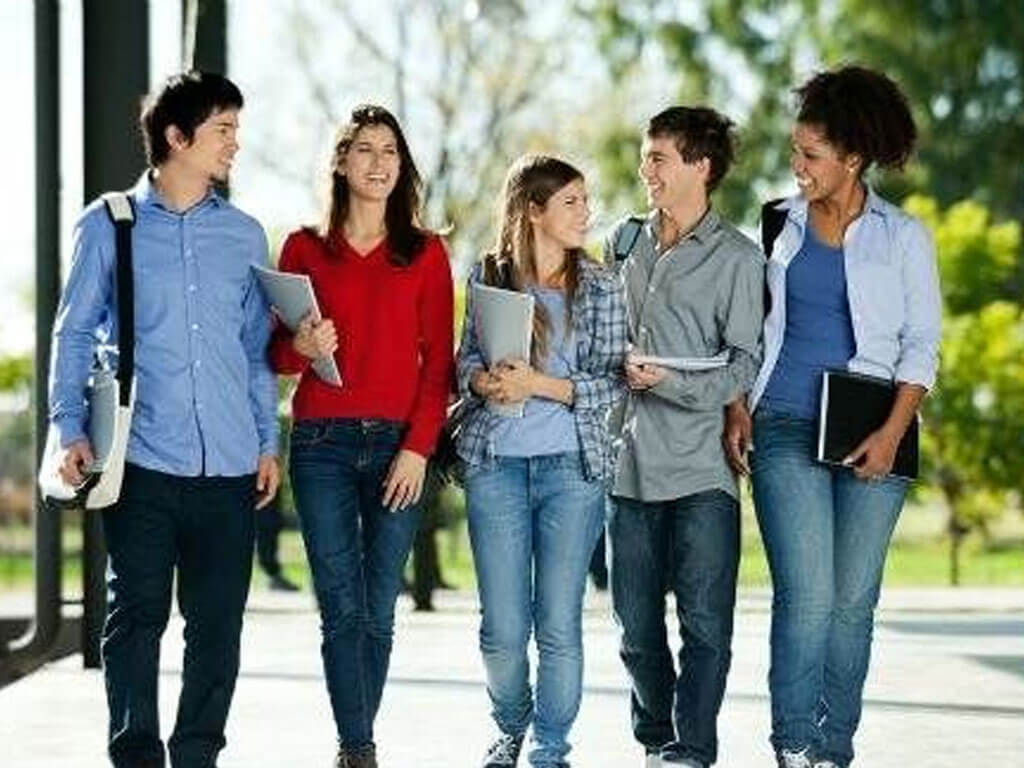 Group of young students walking together
