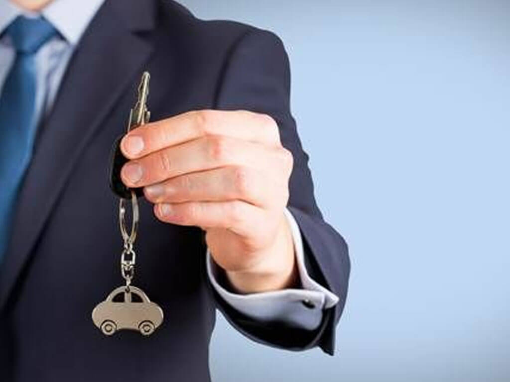 Closeup of hand holding a car key