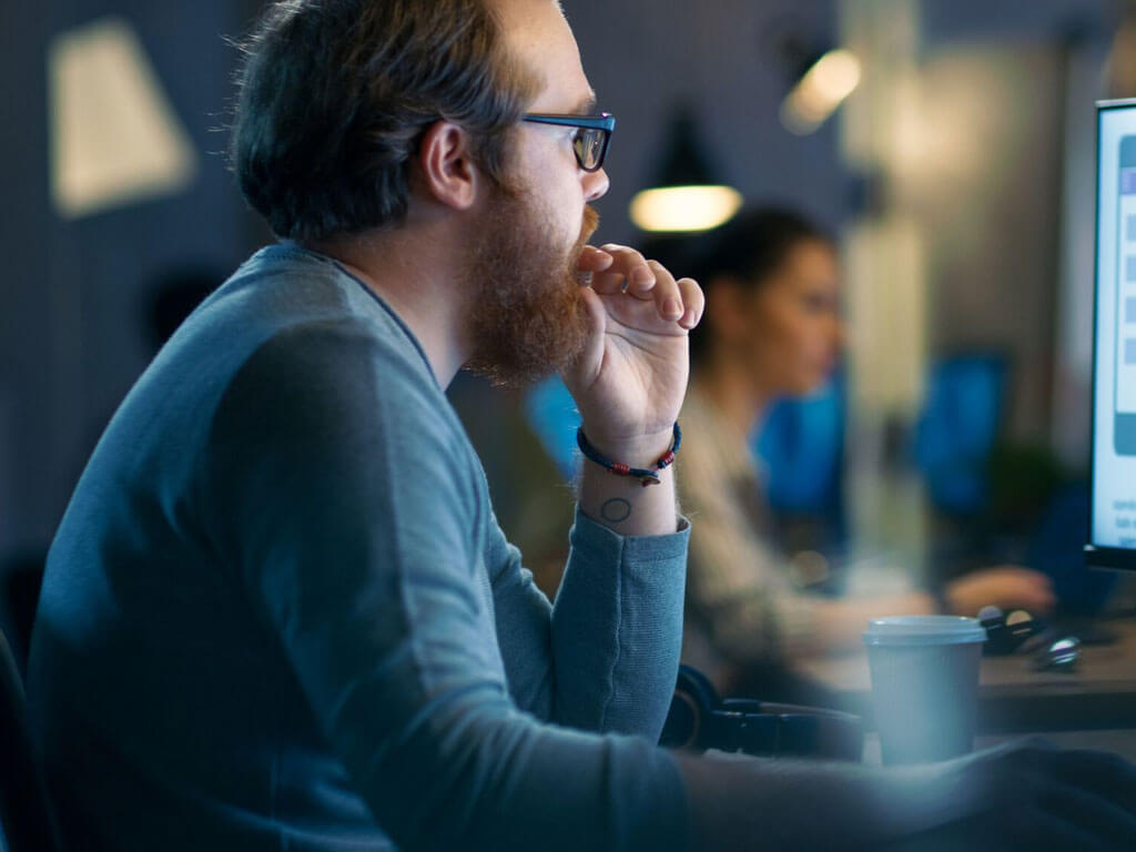 Man looking at a desktop screen