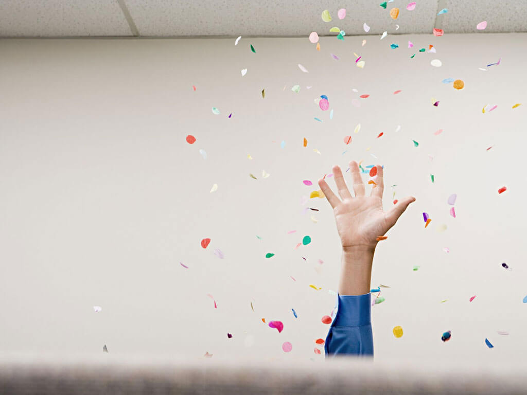 Hand up throwing confetti