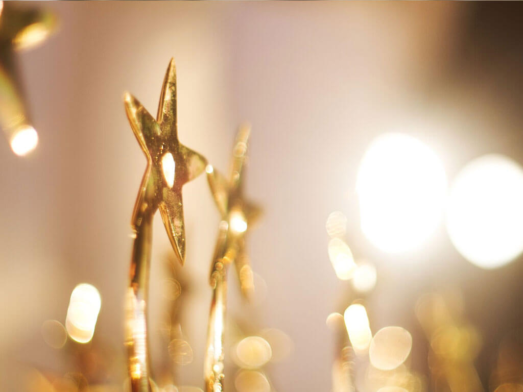 Several golden stars blurred - one is on focus
