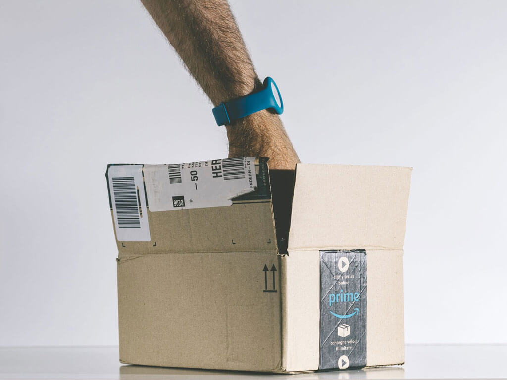 Hand in a Amazon delivery box