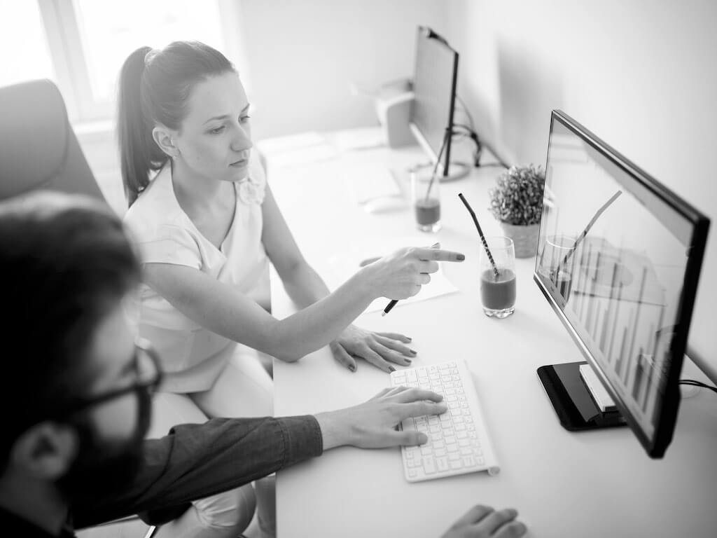 Woman pointing at a computer screen