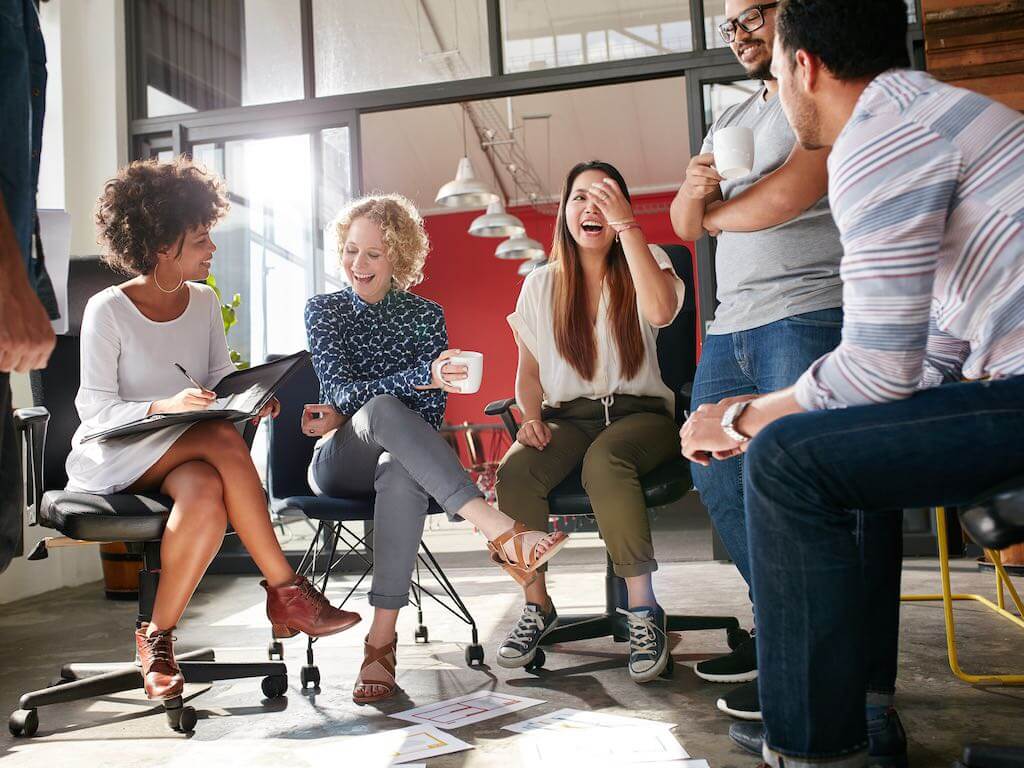 People smiling in a team meeting