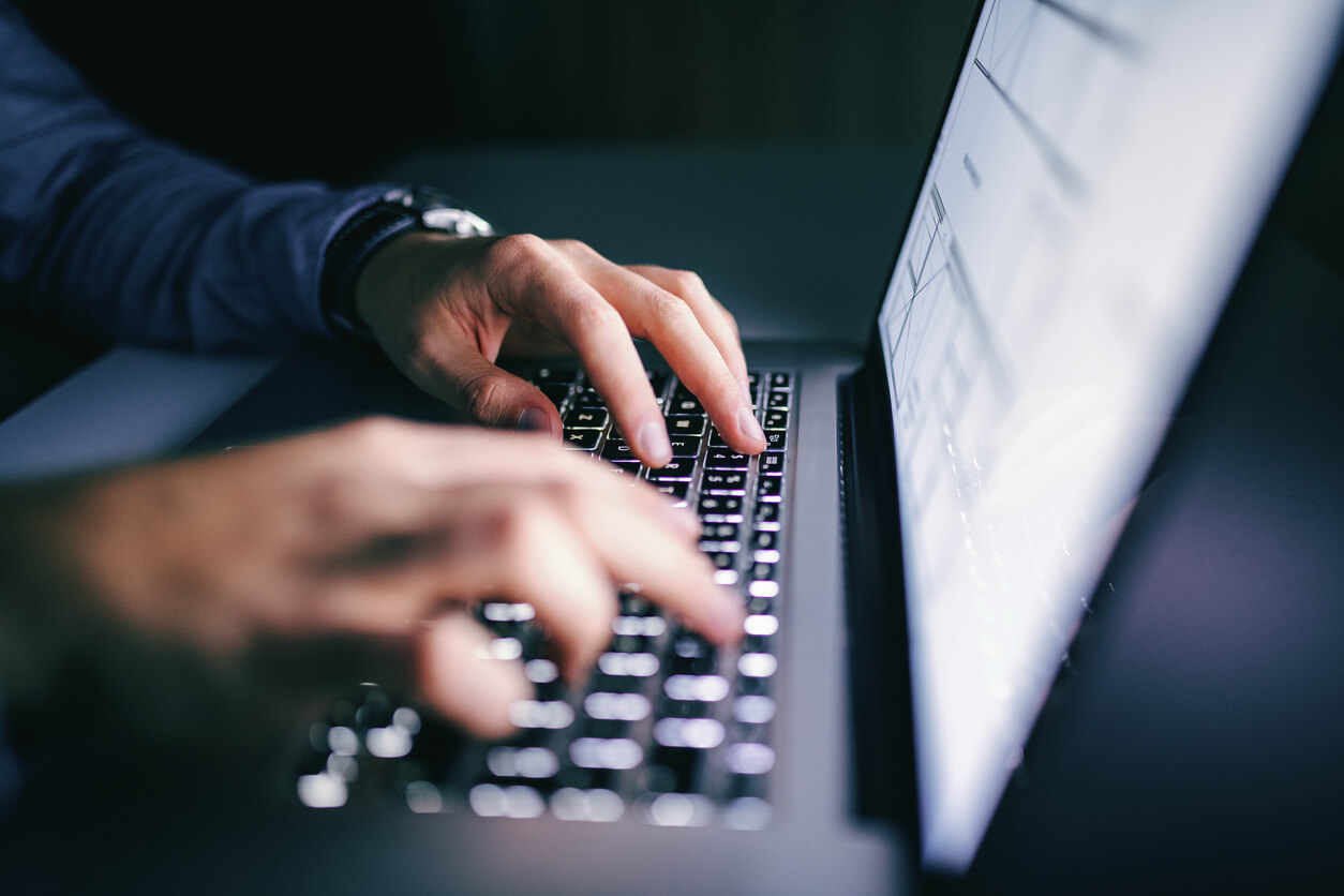 Man typing on a laptop